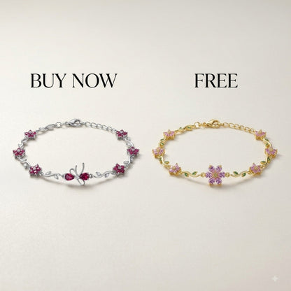Two floral star charm bracelets displayed side by side on a light beige background with promotional text 'BUY NOW' above the silver bracelet and 'FREE' above the gold bracelet.