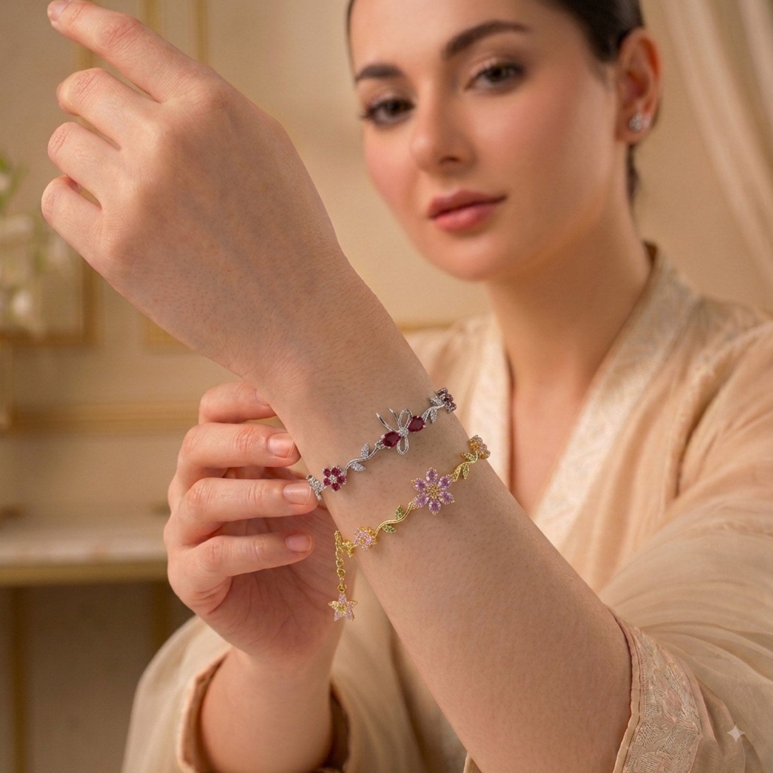 A woman wearing delicate star-shaped bracelets on her wrist, showcasing the jewelry in a warm, elegant indoor setting.